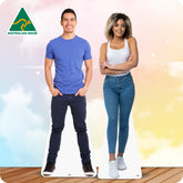 Cardboard cutouts of a man and woman standing on a wooden floor with a colorful background.
